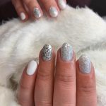 Short White And Silver Glitter Nails Against Fur Background