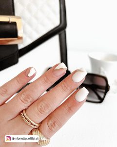 Short White Square Nails With Gold Glitter Wavey Line Across Two Nails
