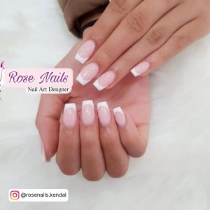 Short White Tip Acrylic Nails On A White Surface