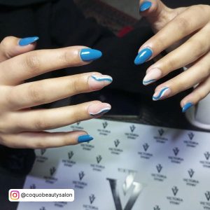 Simple And Classic Blue And White Swirl Nails With Plain Blue Polish