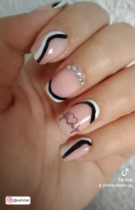 Simple Black And White Nails Inspo With Heart Design, Reverse And Normal Double French Tips, And Rhinestones