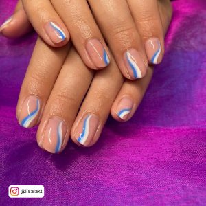 Simple Blue And White Swirl Nails On Velvet Purple Surface