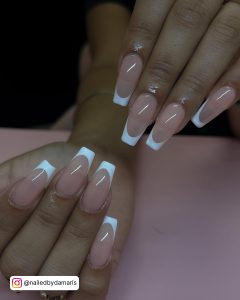 Simple White Tip Acrylic Nails On Peach Surface