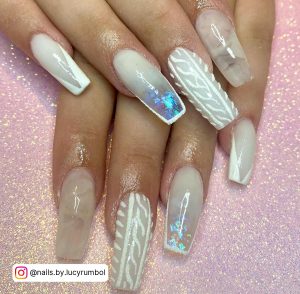 Sparkly Clear White Acrylic Nails With Marble And Blue Sparkly Design Over Pink Glittery Surface