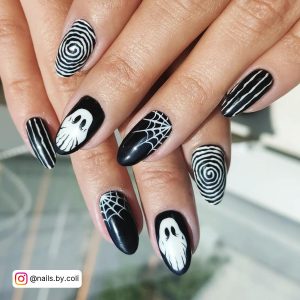 Spooky Oval Black And White Nail Design Idea With Spider Art, + Swirly, Ghost, And White Stripes