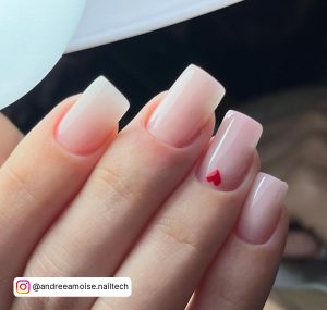 Square Tip Milky White Nails With One Small Red Heart On One Nail