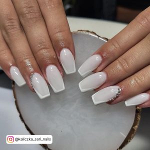 Square Tip Milky White Nails With White French Tip And Silver Rhinestones On Two Cuticles