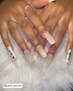 Tapered White Acrylic Nails With Rhinestones, V Tips, Ombré Design And Marble Nails On White Fur.