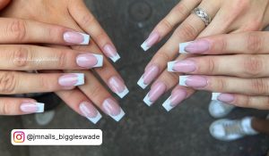 Two Girls Displaying Their Simple White French Tip Coffin Nails