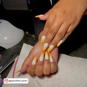 White Almond Nails With Orange Flames On The Tips