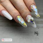 White Almond Nails With Two Sparkle Glitter Nails And One Nail With Rhinestones