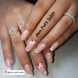 White And Pink French Tip Nails Paired With Rings
