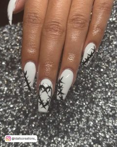 White Coffin Nails Design With Bats Drawn In A Heart Shape
