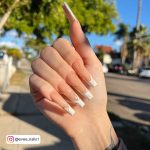 White French Nails In Front Of A Tree