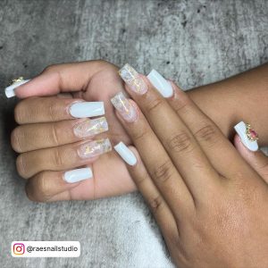 White Nails With Marble Design On Two Fingers