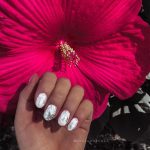 White Oval Nails With Silver Foil Against Flower Background