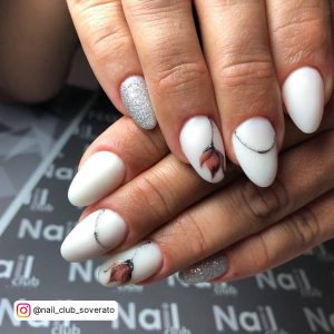 White Oval Nails With Silver Glitter Feature Nail And Flower Designs
