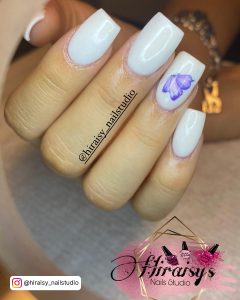White Square Nails With A Purple Butterfly Design On One Nail