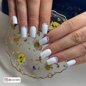 White Square Nails With Rhinestones On The Cuticles Of Two Nails