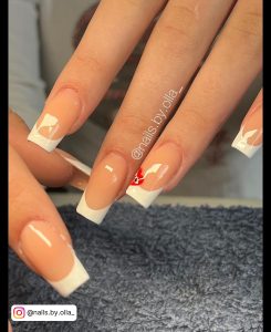 White Tip French Nails With A Small Red Flower On One Finger