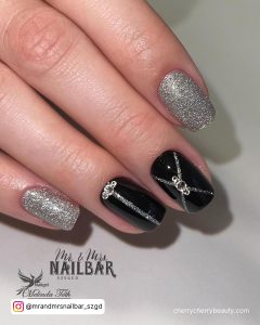 Acrylic Black And Silver Nails With Design On Two Fingers