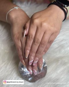 Almond Nails With White Outline On A White Surface