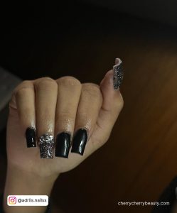 Black Acrylic Nail With Silver Design On Ring Finger And Thumb