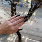 Black Acrylic Nails With One Nail In Golden