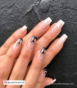 Black And White Flame Nails On A Black Surface