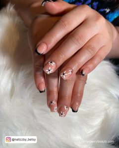 Black And White Flower Nails On A White Surface