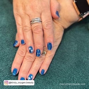 Blue And Silver Snowflake Nails In Short Length