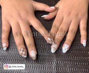 Brown And White Nail Designs On A Table