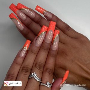 Coffin Orange Acrylic Nails With Lines On Tips