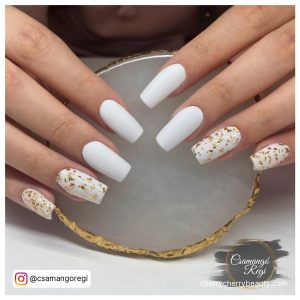 Coffin White Matte Nails With Golden Design On Two Fingers