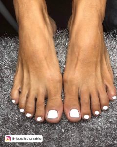 Cute Summer White Toe Nails Design On Grey Fur