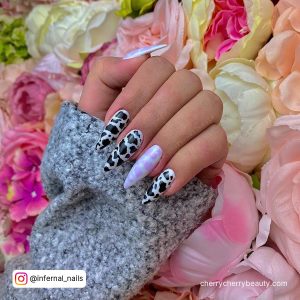 Dark Purple And White Nails On A Floral Surface