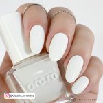 Easy Round Summer White Nails Holding Orosa Nail Polish Over White Background