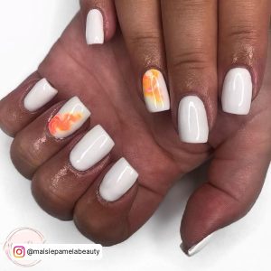 Fiery Orange And White Summer Gel Nails On White Surface