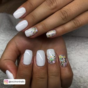 Glossy White Summer Coffin Nails With Multicolored Flakes Over White Towel