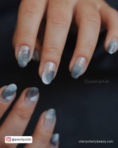 Gray And White Nail Art On A Black Surface