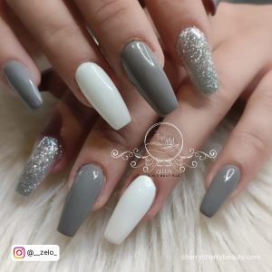Gray White And Silver Nails On A White Surface