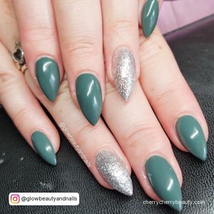 Green Nails With Silver Glitter In Stilleto Shape