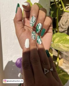 Green White Nail Designs In Front Of A Plant