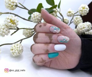 Green White Nails In Front Of A Plant