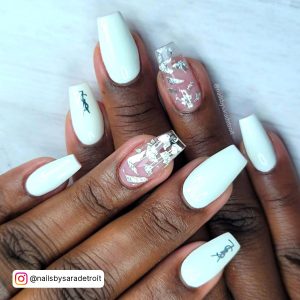 Jelly White Summer Nails With Silver Flakes And Louis Vuitton Brand Logo Design Over White Surface