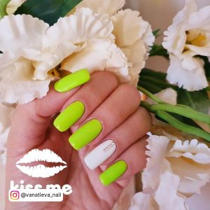 Lime Green And White Nails In Front Of Flowers