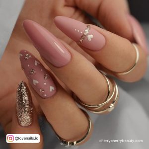 Long Almond Shape Pink And Gold Valentine Nails With Gold Glitter Nail And Gold Glitter Heart Designs On Light Pink Nails