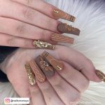 Long Brown Acrylic Nails With Flowers And Patterns