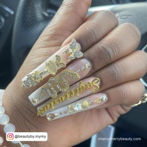 Long Clear Coffin Nails With Crystal And Gold 3D Nail Decoration Including Gold And Crystal 3D Snake And Gold Sagittarius Writing