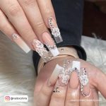 Long Coffin Nails With Nude And White French Tip And Ombre, White Flower Design And Silver Rhinestones
